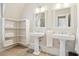 Spacious bathroom with double pedestal sinks and built-in shelving at 738 Hibbens Grant Blvd, Mount Pleasant, SC 29464