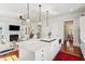 White kitchen with island, stainless steel appliances, hardwood floors, and view to Gathering room at 738 Hibbens Grant Blvd, Mount Pleasant, SC 29464