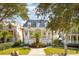 Two story home with a metal roof, front porch, and manicured lawn at 738 Hibbens Grant Blvd, Mount Pleasant, SC 29464