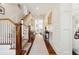 Light-filled hallway with hardwood floors, featuring a staircase and views to living areas at 738 Hibbens Grant Blvd, Mount Pleasant, SC 29464