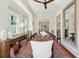 Bright dining room with a rustic wooden table and large windows at 738 Hibbens Grant Blvd, Mount Pleasant, SC 29464