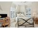 Well-lit bedroom with a bed, desk and chair, and window with shutters at 738 Hibbens Grant Blvd, Mount Pleasant, SC 29464