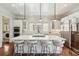 Spacious kitchen boasts white cabinets, large island, stainless steel appliances, and hardwood floors at 738 Hibbens Grant Blvd, Mount Pleasant, SC 29464