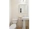 Simple bathroom with pedestal sink, toilet and a framed mirror at 738 Hibbens Grant Blvd, Mount Pleasant, SC 29464
