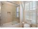 Updated bathroom with a shower/tub and window with shutters at 738 Hibbens Grant Blvd, Mount Pleasant, SC 29464