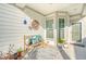 Inviting front porch with a bench, plants, and a decorative rug at 176 Garden Gate Way, Summerville, SC 29486