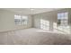 Well-lit bedroom with carpet flooring and two large windows at 1866 Nola Run, Summerville, SC 29485