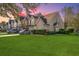 Townhome exterior at sunset with two-car driveway and landscaping at 1106 Poplar Grove Pl, Summerville, SC 29483