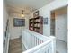 Upstairs hallway with white railing, built-in shelving, and carpet at 1106 Poplar Grove Pl, Summerville, SC 29483