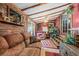 Bright sunroom with comfy seating and wood-paneled walls at 115 Galloway Ct, Moncks Corner, SC 29461