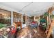 Relaxing screened porch with fireplace and wicker furniture at 115 Galloway Ct, Moncks Corner, SC 29461