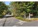 Gravel driveway entrance, leading to a home with a charming mailbox and bicycle at 115 Galloway Ct, Moncks Corner, SC 29461