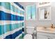 Simple bathroom with a shower/tub, striped shower curtain, and white vanity at 807 Mountain Pine Rd, Moncks Corner, SC 29461