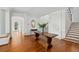 Elegant entryway with hardwood floors, antique console table, and grand staircase at 140 Flyway Dr, Kiawah Island, SC 29455