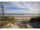 Wooden walkway to beach with dunes and ocean view at 140 Flyway Dr, Kiawah Island, SC 29455