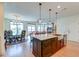 Modern kitchen with granite island, stainless steel appliances, and hardwood floors at 2202 Folly Rd, Charleston, SC 29412