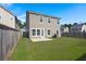 Large backyard with a patio and wooden fence at 213 Lazy River Ln, Moncks Corner, SC 29461