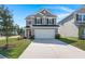 Two-story home with gray siding and two-car garage at 213 Lazy River Ln, Moncks Corner, SC 29461