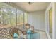 Relaxing screened porch with wicker chairs and a view of the backyard at 202 Greenmeadow Dr, Goose Creek, SC 29445