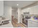 Modern kitchen with white cabinets and stainless steel appliances at 202 Greenmeadow Dr, Goose Creek, SC 29445