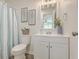 Bathroom with white vanity and blue shower curtain at 202 Greenmeadow Dr, Goose Creek, SC 29445