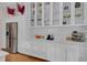 White kitchen with glass-front cabinets and stainless steel appliances at 413 King St, Mount Pleasant, SC 29464