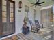 Welcoming front porch with rocking chairs and stylish decor at 413 King St, Mount Pleasant, SC 29464