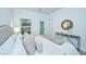 Bright bedroom with a queen bed, neutral decor, and an exterior door at 601 Twin Rivers Dr, Wando, SC 29492