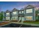 Three gray townhouses with white doors and landscaping at 601 Twin Rivers Dr, Wando, SC 29492