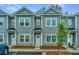 Three gray townhouses with white doors and landscaping at 601 Twin Rivers Dr, Wando, SC 29492