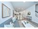 Open concept living area with gray sofa, white coffee table, and dining area at 601 Twin Rivers Dr, Wando, SC 29492
