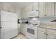 Well-equipped kitchen with white appliances and ample cabinetry at 33 Calhoun Street Apt. 123, Charleston, SC 29401