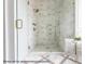 Large walk-in shower with marble tile and built-in seat at 3215 Pine Needle Ln, Seabrook Island, SC 29455