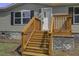 Inviting home exterior with wooden stairs and a light gray facade at 1657 Short Cut Rd, Cross, SC 29436