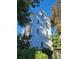Three-story light gray house with white trim and several windows at 24 Iron Frg Aly, Charleston, SC 29403