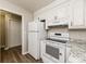 White appliances and granite countertops in this kitchen at 216 Sandra Ln, Ladson, SC 29456