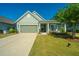 Charming one-story home with a two-car garage and landscaped lawn at 145 Hedera Ct, Summerville, SC 29486