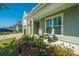 Relaxing covered porch with seating, surrounded by lush landscaping at 145 Hedera Ct, Summerville, SC 29486