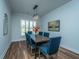 Bright dining room features hardwood floors, a rustic wood table, and blue chairs at 145 Hedera Ct, Summerville, SC 29486