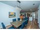Open dining room with a rustic table and chairs, and views into the kitchen and living areas at 145 Hedera Ct, Summerville, SC 29486