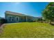 Large backyard with grassy lawn, patio, and a view of neighboring homes at 145 Hedera Ct, Summerville, SC 29486