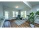 Spacious living area with hardwood floors, large windows, and access to a patio at 145 Hedera Ct, Summerville, SC 29486