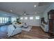 Living room with hardwood floors, large windows, and comfortable seating at 145 Hedera Ct, Summerville, SC 29486