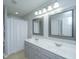 Double vanity bathroom with shower and gray cabinets at 2917 Fernwood Dr, North Charleston, SC 29406