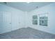 Spacious bedroom with gray carpet and two windows at 801 Twin Rivers Dr, Wando, SC 29492