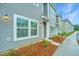 Gray townhouse exterior with landscaping and walkway at 801 Twin Rivers Dr, Wando, SC 29492