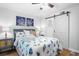 Beach-themed bedroom with a queen-size bed and barn door at 121 High Hammock Villas # 121, Seabrook Island, SC 29455