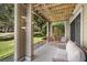 Covered patio with comfortable seating, overlooking the garden at 121 High Hammock Villas # 121, Seabrook Island, SC 29455