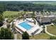 Aerial view of community pool, clubhouse, and surrounding landscape at 121 High Hammock Villas # 121, Seabrook Island, SC 29455