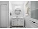White bathroom vanity with a round mirror and updated fixtures at 121 High Hammock Villas # 121, Seabrook Island, SC 29455